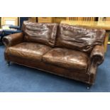 A BROWN LEATHER THREE SEAT SETTEE