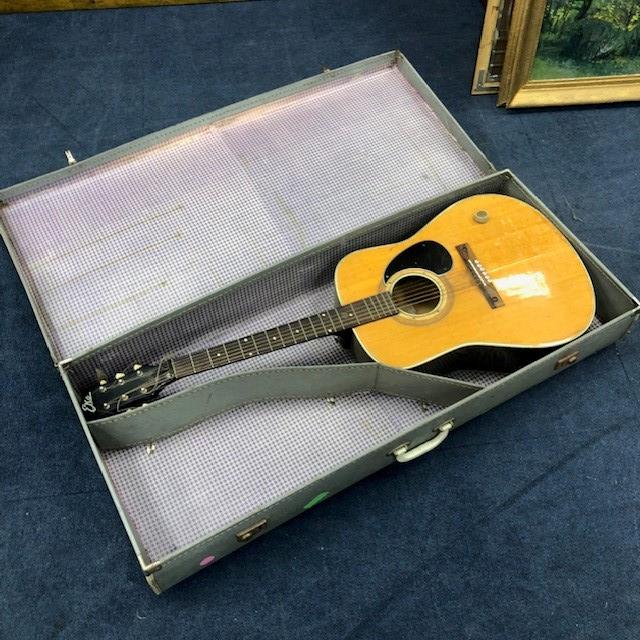 AN ACOUSTIC GUITAR IN CASE