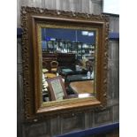 A CARVED WOOD AND BRASS FRAMED RECTANGULAR WALL MIRROR
