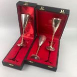 A PAIR OF SILVER CHAMPAGNE FLUTES AND ANOTHER