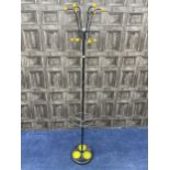 A RETRO BLACK ENAMELLED HAT AND COAT STAND