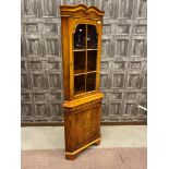 A MODERN YEW WOOD CORNER CABINET