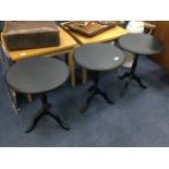 A LOT OF THREE EBONISED CIRCULAR OCCASIONAL TABLES
