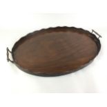 AN EARLY 20TH CENTURY MAHOGANY OVAL TEA TRAY