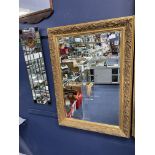 A GILT FRAMED RECTANGULAR WALL MIRROR AND ANOTHER