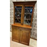 A MAHOGANY BOOKCASE ON CHIFFONIER