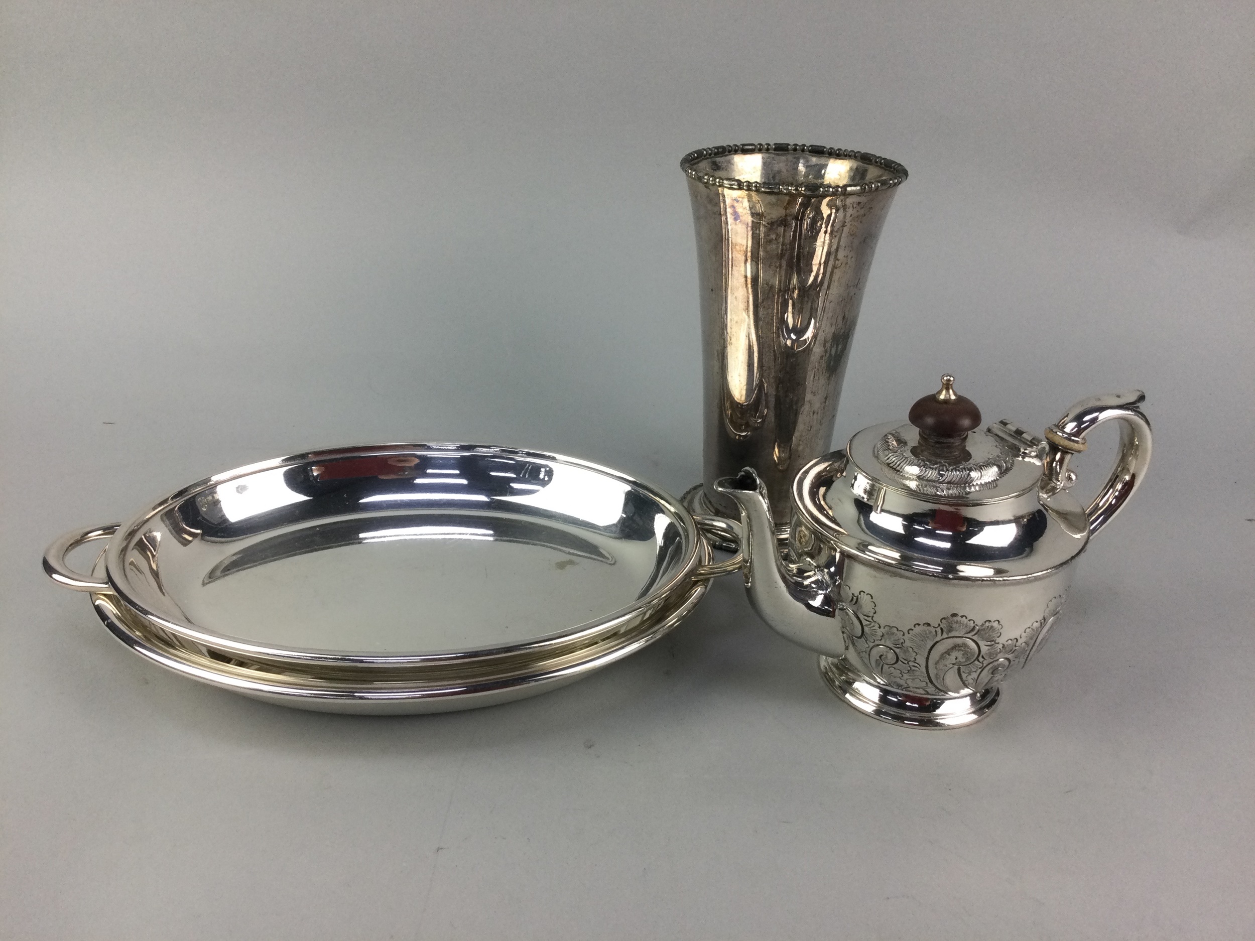 A SILVER PLATED CIRCULAR TRAY AND OTHER PLATE