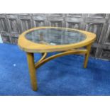 A TEAK GLASS TOPPED COFFEE TABLE