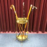 A BRASS SEMI CIRCULAR STICK STAND AND VARIOUS STICKS AND CANES