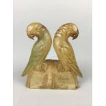 A PAIR OF ITALIAN SOAPSTONE BOOKENDS MODELLED AS PARROTS