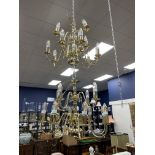 A PAIR OF BRASS CHANDELIERS, ALONG WITH ANOTHER