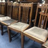 AN EARLY 20TH CENTURY OAK PULL OUT DINING TABLE AND CHAIRS