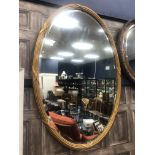 A 19TH CENTURY FRENCH OVAL WALL MIRROR