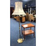 AN OAK TEA TROLLEY AND A BRASS FLOOR LAMP