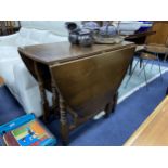 AN OAK DROP LEAF DINING TABLE