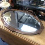 AN OAK OVAL FRAMED WALL MIRROR