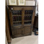 AN OAK GLAZED TWO DOOR BOOKCASE