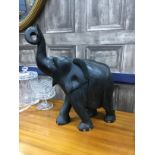 AN EBONISED CARVED WOOD ELEPHANT