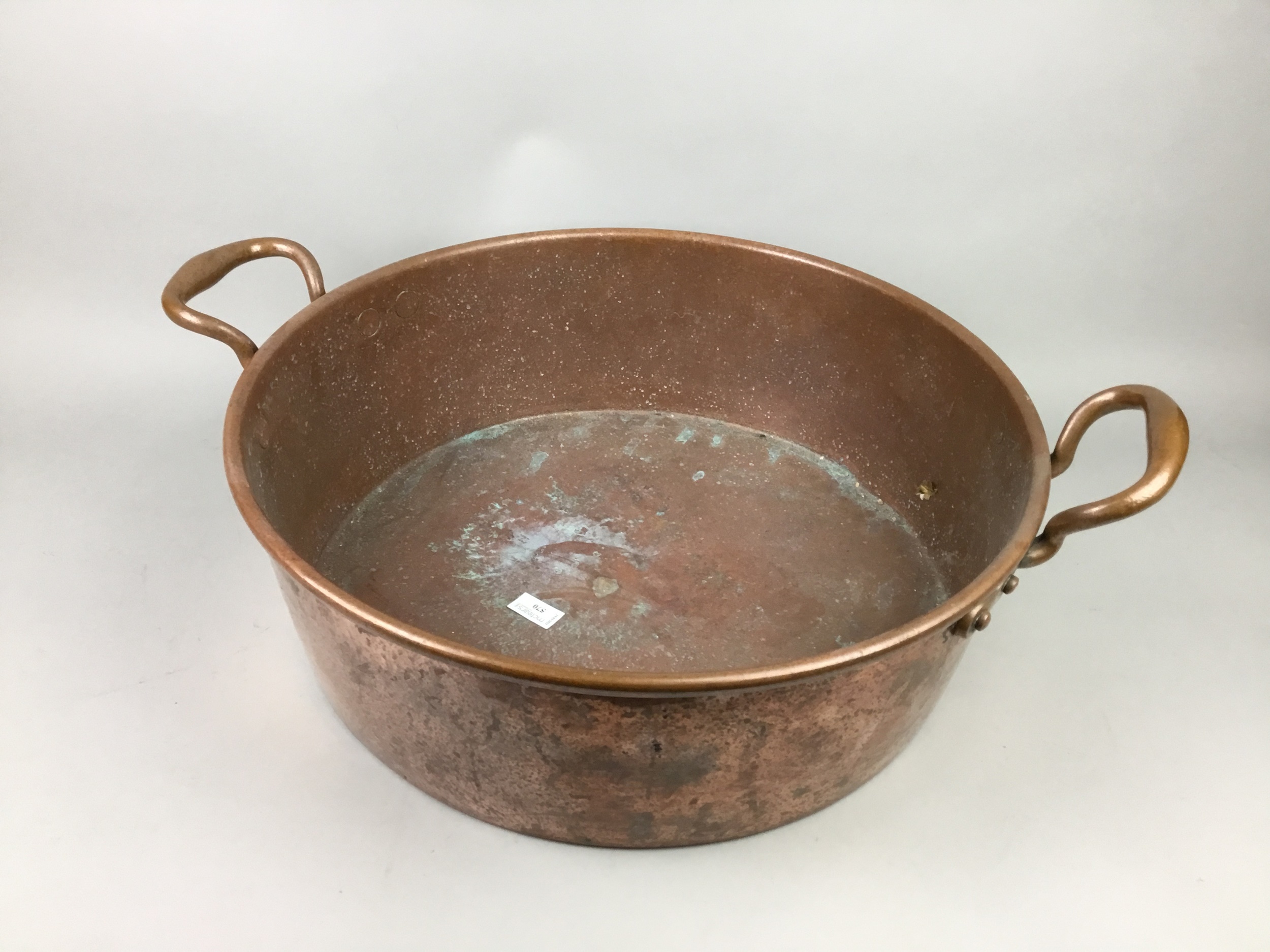 A LARGE COPPER TWIN HANDLED PAN