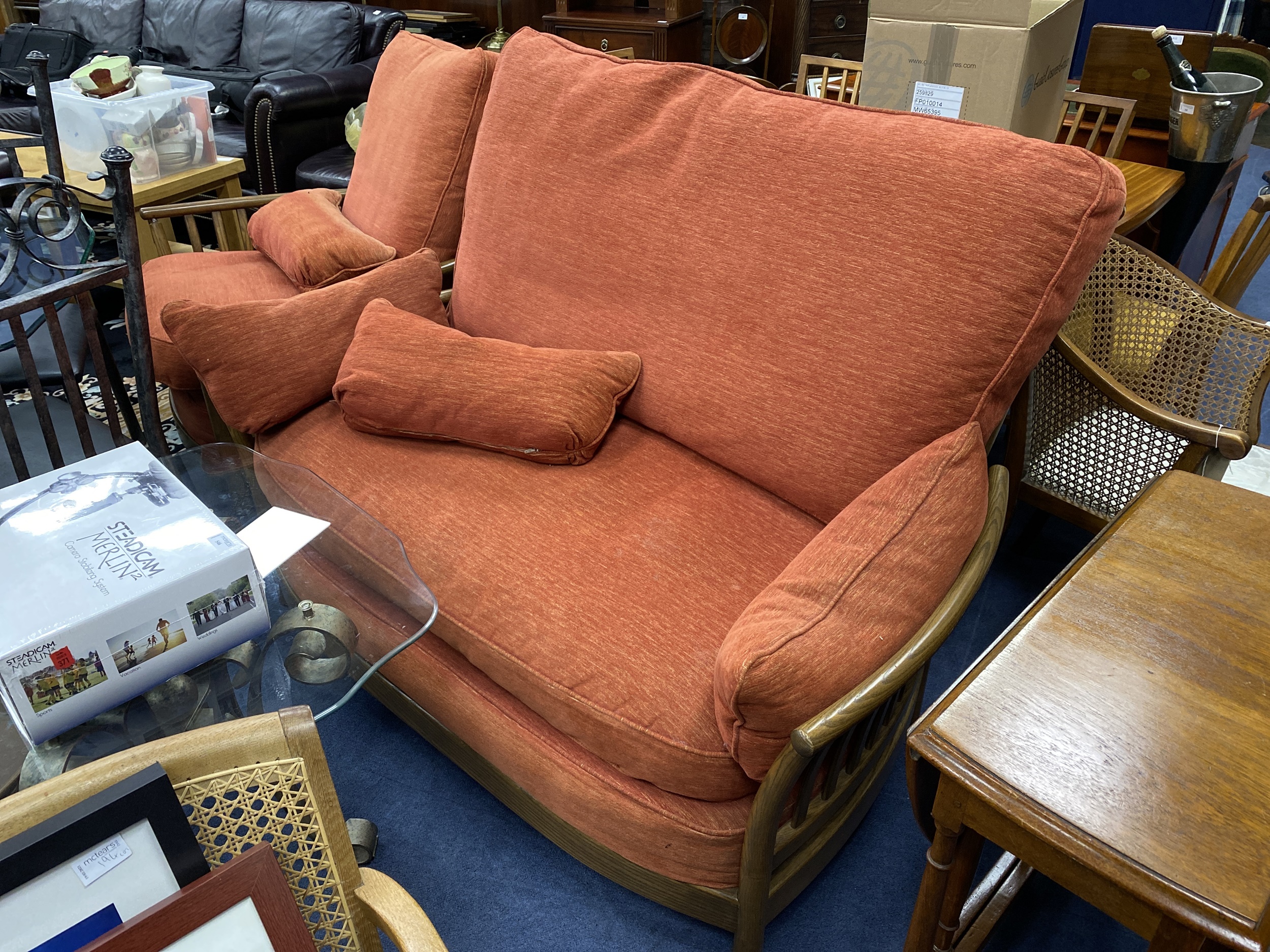 AN ERCOL SETTEE AND MATCHING ARMCHAIR