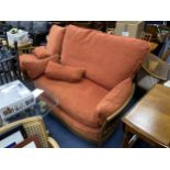 AN ERCOL SETTEE AND MATCHING ARMCHAIR