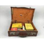 A COLLECTION OF VINTAGE CIGARETTE TINS, ALONG WITH THREE STAMP ALBUMS