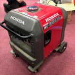 A HONDA INVERTER EU 3000 IS GENERATOR AND A PAIR OF WERNER LADDERS