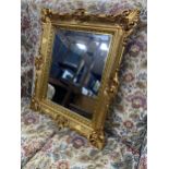 A GILT FRAMED RECTANGULAR WALL MIRROR