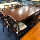 AN OAK EXTENDING DINING TABLE AND SIX CHAIRS