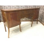 AN EDWARDIAN MAHOGANY SERPENTINE FRONTED SIDEBOARD