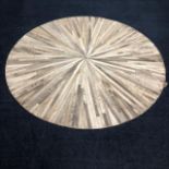 A COWHIDE CIRCULAR RUG