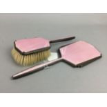 AN ART DECO SILVER AND PINK GUILLOCHE ENAMEL VANITY MIRROR AND BRUSH AND A CLOCK