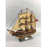 A WOOD MODEL OF H.M.S BOUNTY, FOUR FIGURES AND FOUR CERAMIC PLATES