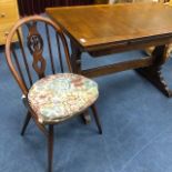 AN OAK EXTENDING DINING TABLE AND FOUR ERCOL CHAIRS