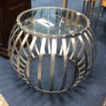 A MODERN STEEL BARREL SHAPED TABLE