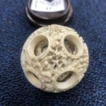 AN EARLY 20TH CENTURY CHINESE CARVED IVORY CONCENTRIC BALL