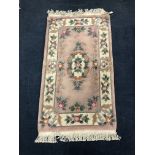 A 20TH CENTURY CHINESE FRINGED RUG AND TWO OTHER RUGS