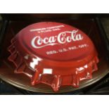 A COCA COLA BAR COUNTER BOTTLE OPENER AND A COCA COLA SIGN