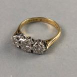 A DIAMOND THREE STONE RING SET IN EIGHTEEN CARAT