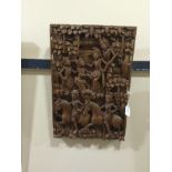 AN INDONESIAN CARVED WOOD RECTANGULAR PLAQUE