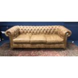 A BROWN LEATHER CHESTERFIELD THREE SEAT SETTEE