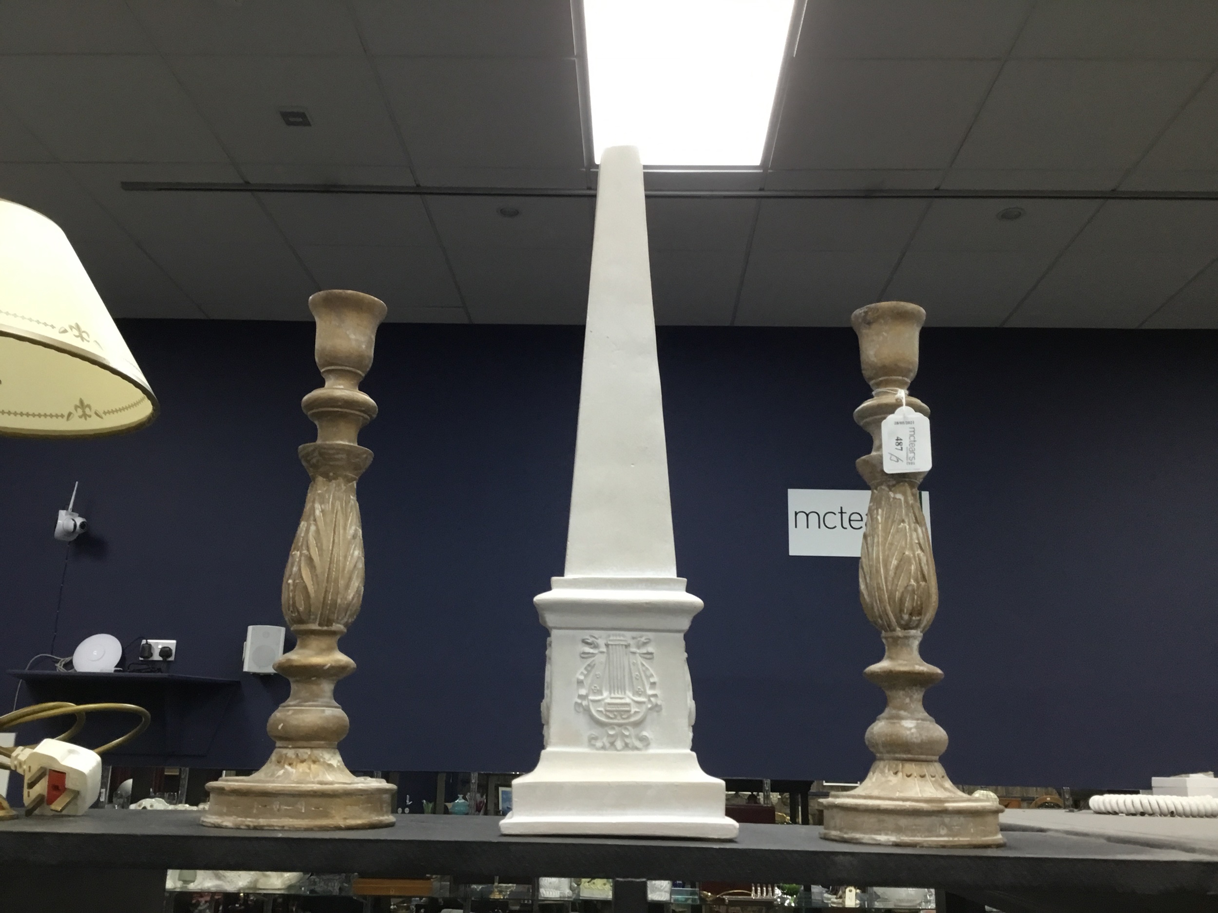 A PAIR OF CARVED WOOD CANDLESTICKS AND AN OBELISK