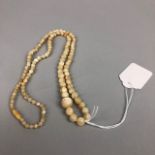 A MOTHER OF PEARL GRADUATED BEAD NECKLACE