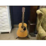 A CARLTON ACOUSTIC GUITAR AND STAND