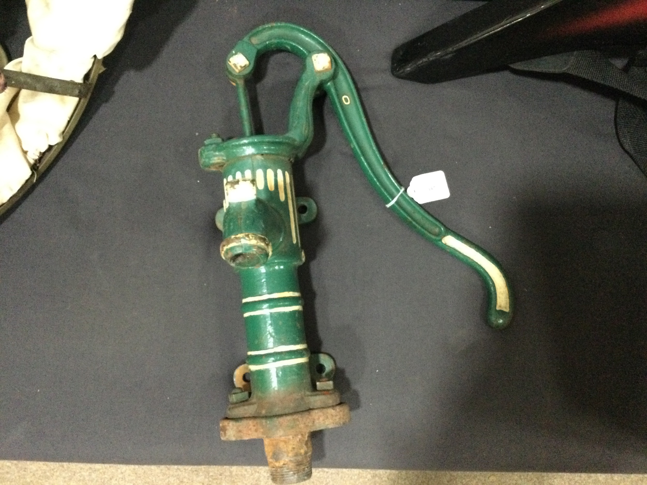 A PAINTED IRON WATER PUMP