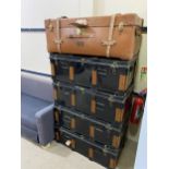 A LEATHERETTE TRUNK AND FOUR METAL TRUNKS