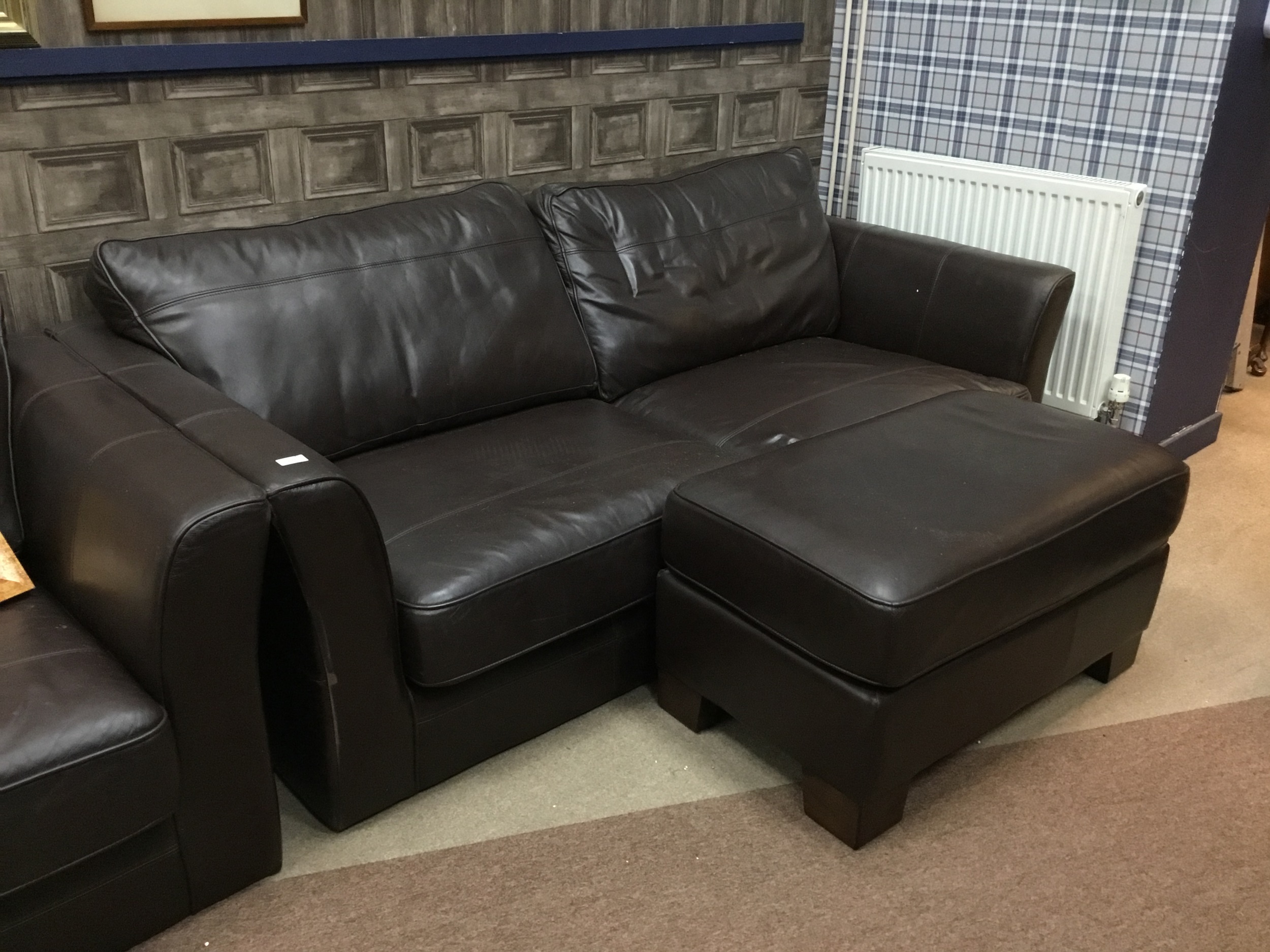 A BROWN LEATHER THREE SEATER SETTEE, A TWO SEATER AND A POUFFE