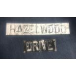 A PAIR OF STREET SIGNS MARKED 'HAZELWOOD' AND 'DRIVE'