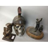 A MODEL OF SKULL IN GLADIATOR HELMET, GOLFING TROPHY AND A GOLFING FIGURE