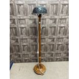 A WALNUT FLOOR LAMP WITH LEADED GLASS SHADE